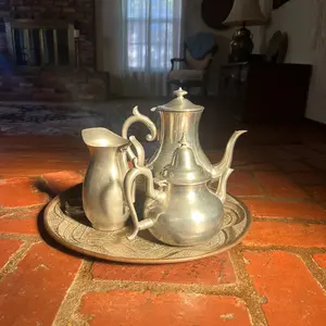 Antique metal silver Turkish tea set with hand engraved art on the plate. Floral design. vintage. Ancient art