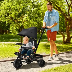 Black 4 in 1 Foldable Kids Tricycle for toddlers aged 1 to 5, built with reversible seat, 3-gear adjustable push handle, removable canopy, 3-point harness, wheel brakes and multiple storage spaces