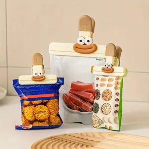 4-piece set of cute duck-designed food bag clips - Sturdy plastic sealing clips with a playful smile and big eyes to keep snacks fresh. Safe kitchen storage accessories and sealing tools for packaging potato chips, cookies, and grains, 2 large and 2 small