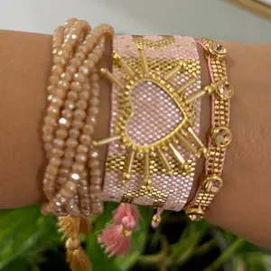 Spectacular Miyuki set of three bracelets, pink with gold hearts and another with crystals.