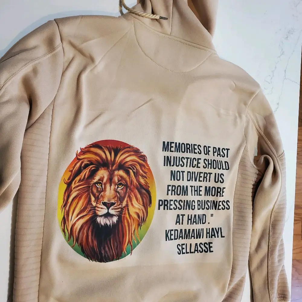 Rasta Style Hoodie with Lion Graphic Design and "MEMORIES OF PAST INJUSTICE SHOULD NOT DIVERT US FROM THE MORE PRESSING BUSINESS AT HAND" Text - Nata, Snack