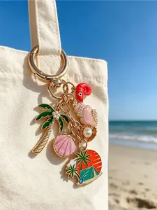 Ocean beach themed alloy charm decorated with pearls, shells and coconut trees. A travel-inspired pendant ideal for seaside holidays. Perfect as small gifts and souvenirs for birthdays, Mother’s Day, anniversaries and back-to-school.