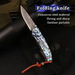 Multifunctional camping knife with a blade made of multi-layer folded forged Damascus steel, featuring high hardness and a handle displaying an iridescent luster of interwoven blue, green, and purple.