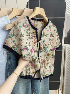 Women's khaki bohemian vacation short-sleeve knit top. Loose round neck, contrast all-over Floral print, front tie and contrast piping. Comfortable for spring & summer casual wear.