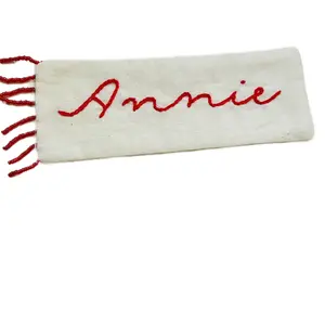 Custom hand embroidered name bookmark with beaded fringe.