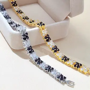 New - style Four - leaf Clover Bracelet. Crafted with copper electroplated in gold and silver and adorned with black cubic zirconias.