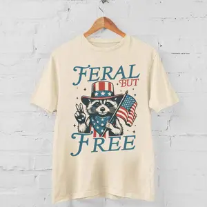 [Sale Up To 45%] Feral Freedom T-Shirt, Patriotic Raccoon with Flag Graphic, Perfect for July 4th Celebrations, Fun & Bold Summer Tee
