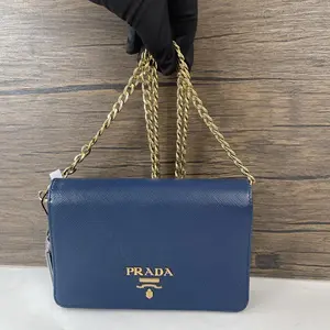 Pre-owned PRADA leather Crossbody Bags navy Saffiano WOC crossbody bag, polished gold logo plaque & dual interwoven metal chain strap.ttt