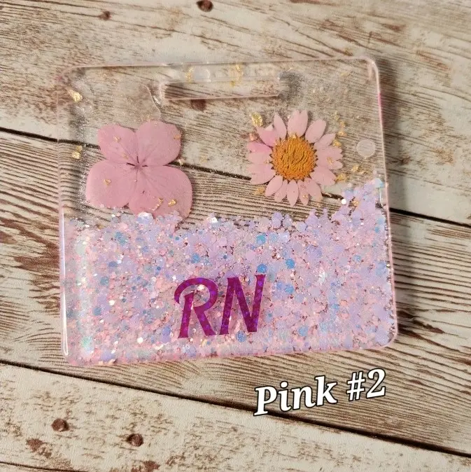 Personalized Glitter Pink Flowers Badge Buddy for Medical Professionals - Acrylic Blanks, Epoxy Resin, Vertical Design, Smooth Finish, Black & Gold Foil, RN Title Customization, Multiple Colors, Flowers & Gold Foil, Customizable