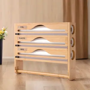 A space management tool for kitchen optimizers, The bamboo cutter with integrated paper towel holder solves categorized storage of wrapping films, Cling film, and tissues in cooking zones through its consolidated design, enhancing kitchen efficiency