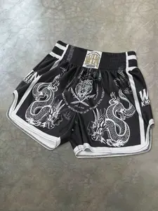 Vintage street-style men's Muay Thai shorts with dragon and tiger prints, suitable for training, kickboxing and mixed martial arts.