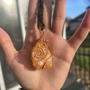 Copper wire wrapped orange calcite