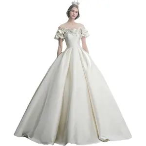 Elegant, princess-style wedding dress with illusion neckline and bell sleeves in satin. Lace-up detailing and A-line accents. Perfect for concerts, recitals, and after-parties.