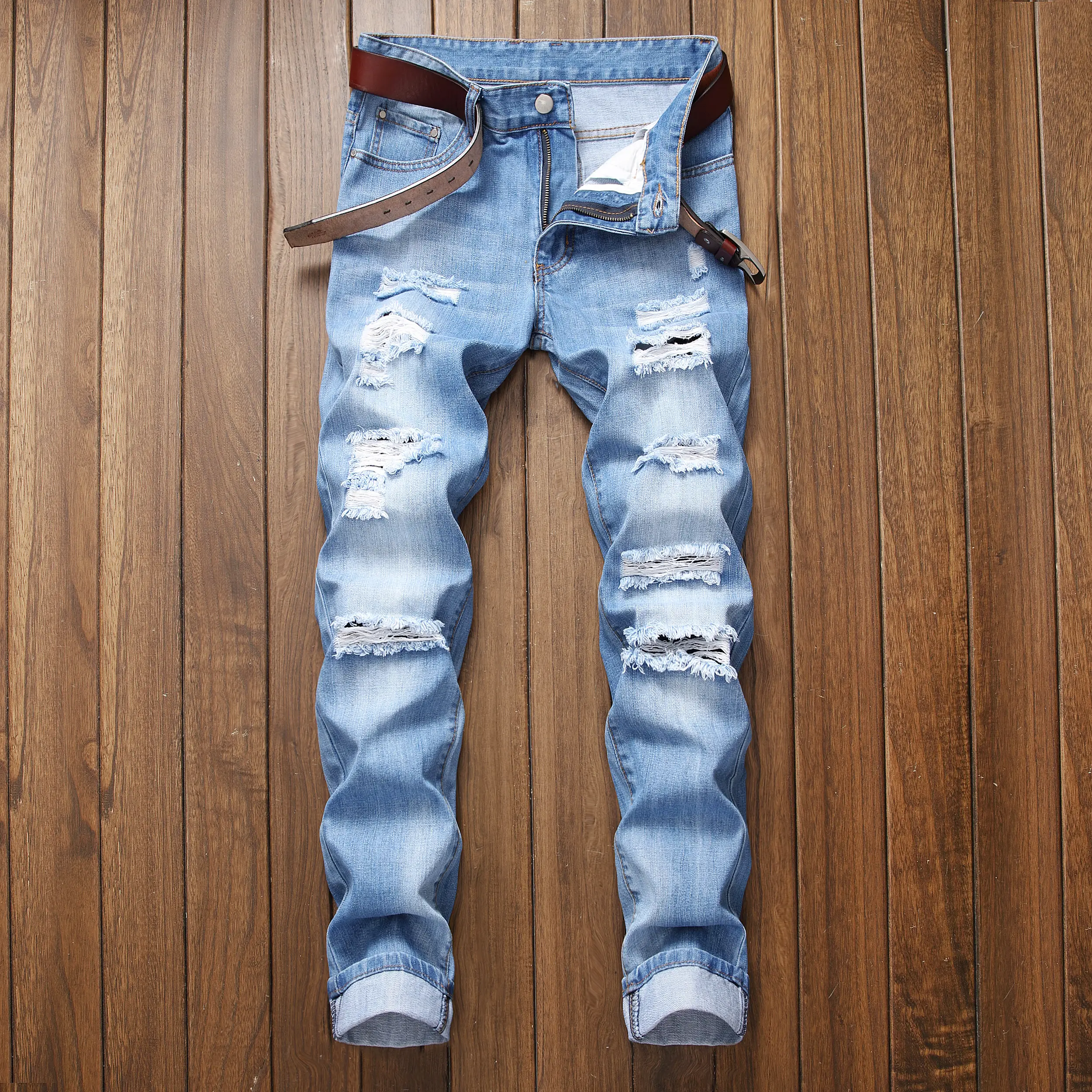 Men's light blue ripped jeans with slim fit and many tattered casual denim pants