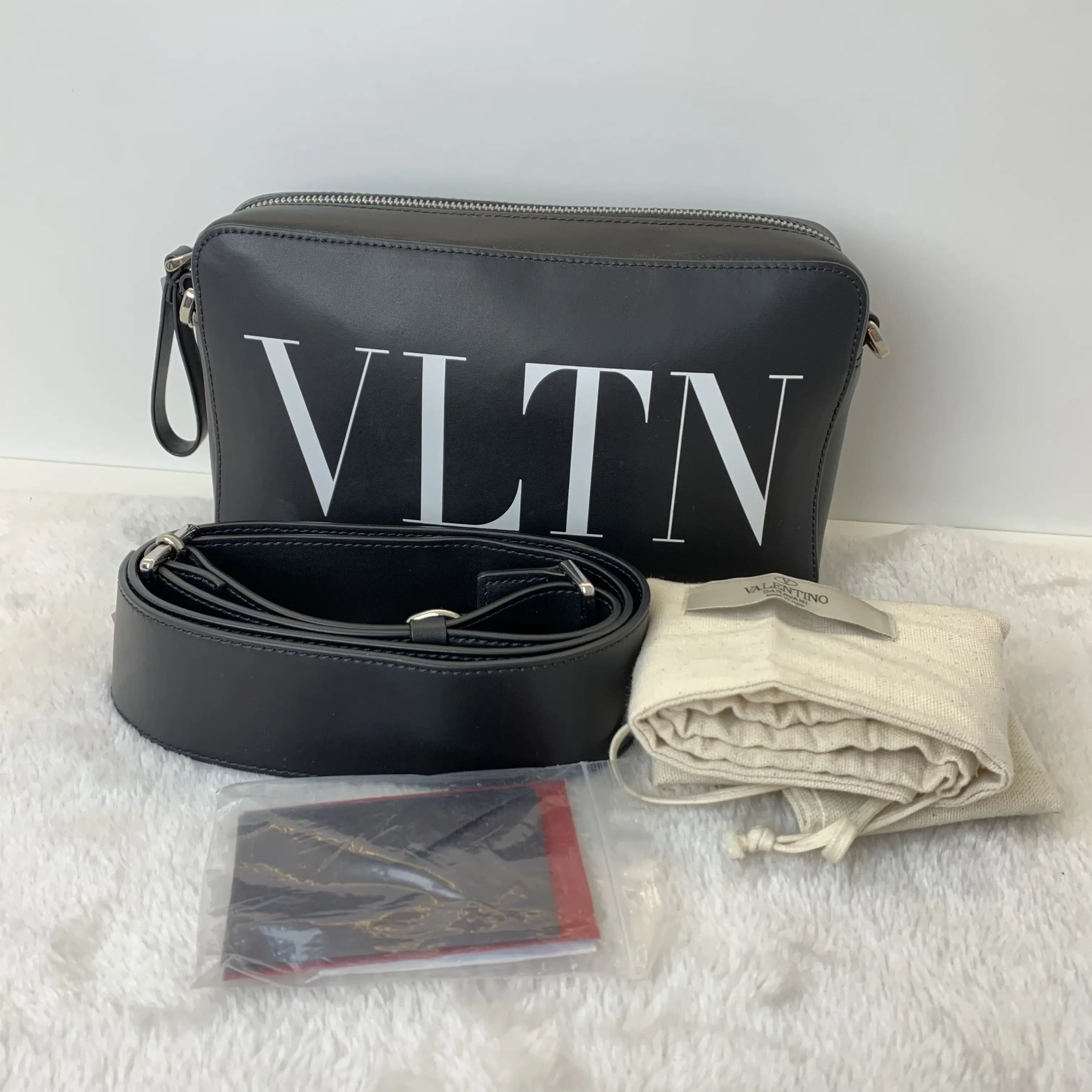 Pre-owned Valentino VLTN Black Smooth Leather Camera Crossbody Bag Travel Friendly, Minimalist, Compact Flat Silhouette, Dual Side Metal D Rings, Includes Full Original Dust Bag & Paper Card Set TKB00000035
