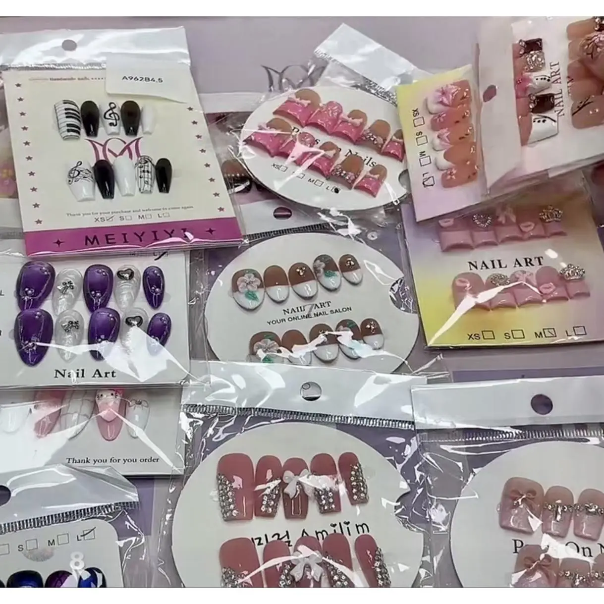 Six Medium Sets of Quality Nails selected for their unique style and Design.  Details Various Colors and Styles