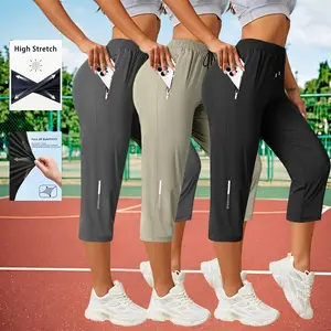 Women’s quick-dry, breathable running fitness pants for night workouts; summer ice silk athletic capris with reflective stripes, high stretch, loose fit, and side zippered pockets.