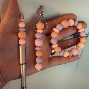 Two silicone beaded keychains and one beaded pen