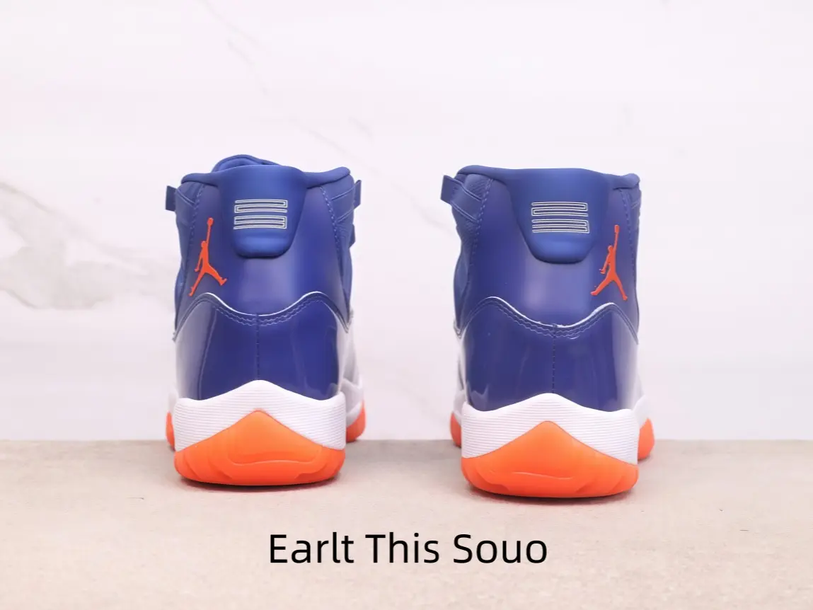 Vibrant royal blue high-top basketball sneakers feature bright orange jumpman logo on the heel, layered white midsole and orange rubber outsole, supportive padded ankle collar suits streetwear and competitive ball games.