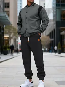 Two-piece men's color-blocking button-down long-sleeve coat with drawstring waistband sports pants, baseball collar jacket and anklelength sports pants, suitable for spring and autumn wear, daily casual outdoor sports suit.