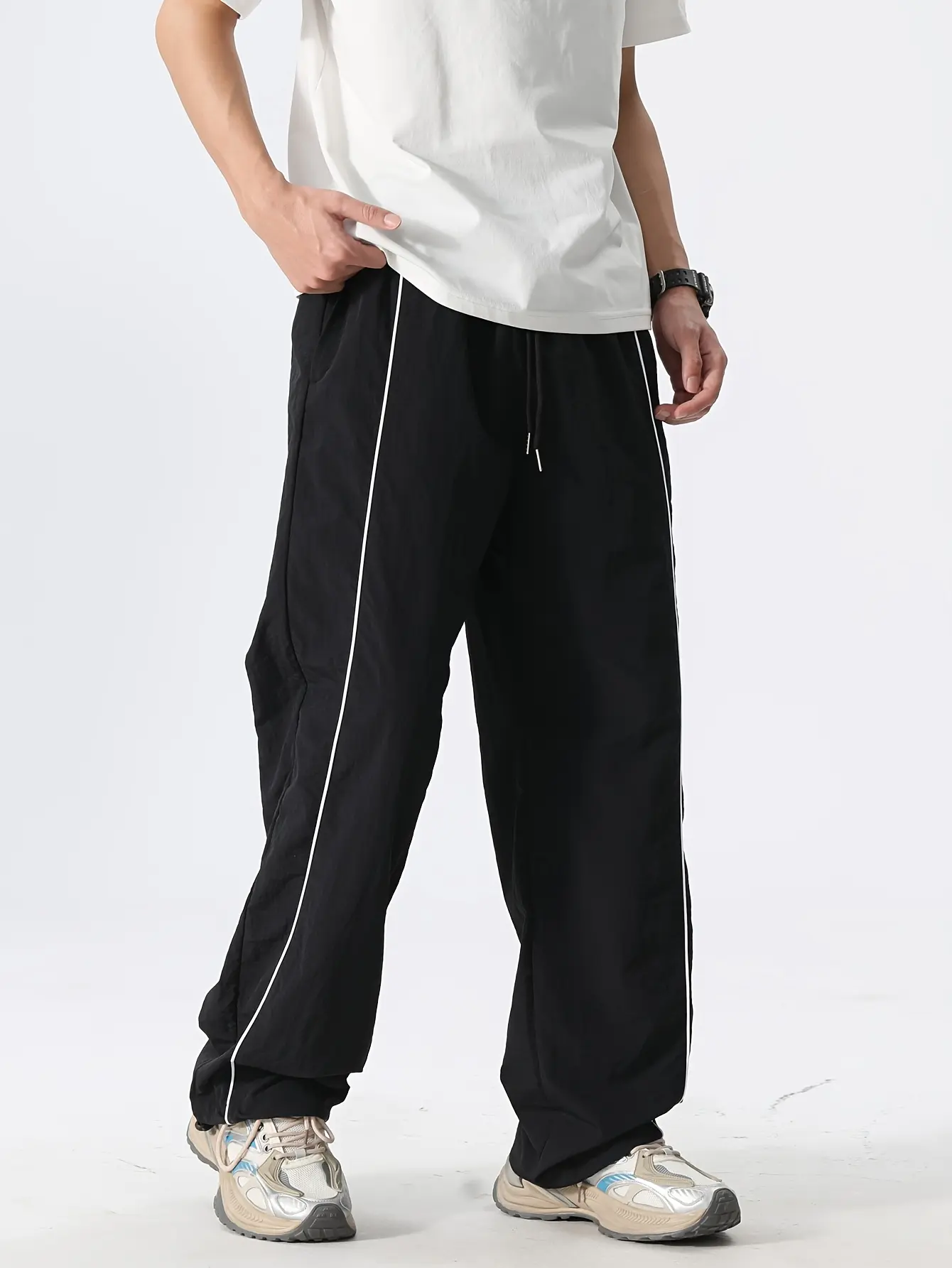 American retro wide-leg athletic pants with adjustable drawstring and white stripes on the side, made of nylon