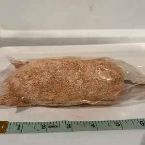 Paquita la del barro- ellottee- white and brown clays and kaolins in a shape of long figure. Wrapped in plastic bag/ made in Mexico
