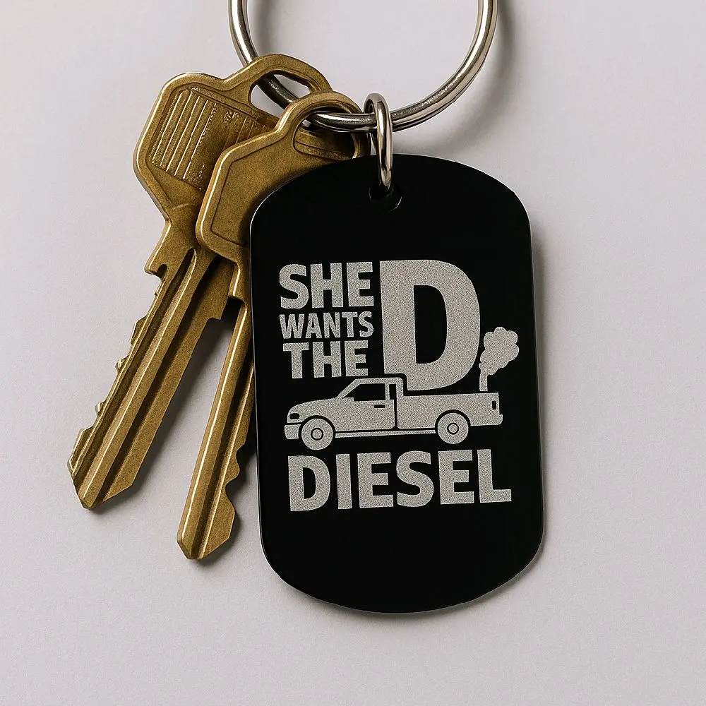 Funny Diesel Keychain – “She Wants the D” Truck Key Tag – Black Anodized Metal – Gag Gift for Him – 2” Metal Keychain