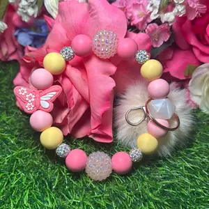 Posh flutters Wristlet Keychain color scheme light pink, light yellow, posh pink and bling beads made with wire
