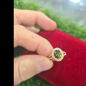 Elegant Green Stone Ring with Intricate Halo Design Perfect for Special Occasions