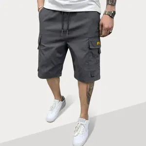 Men’s cargo pants with large pockets and a bright yellow leather patch, loose-fit utility bottoms, breathable lightweight casual trousers for outdoor activities, hiking, and everyday streetwear.
