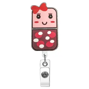 A cartoon with cute shape of the work card retractable buckle, the main body is pink, with red bow and smiley face equipped with a telescopic structure and metal clip, can be used to hang work cards, suitable for love cute decoration scene Badge Holder.