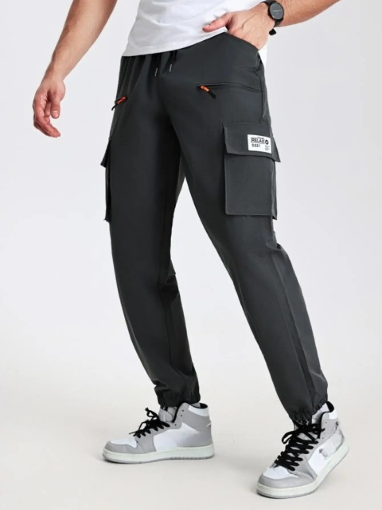 Men’s cargo pants with zippered pockets and elastic drawstring, multi-pocket functional casual long trousers