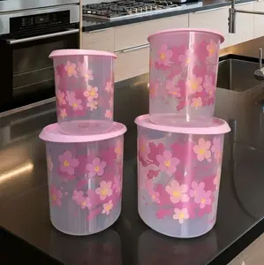Set of dry food storage canisters, translucent with pink decoration.