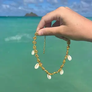 Gold cowry shell necklace