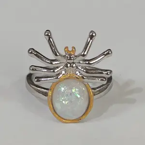 Creative spider-shaped two-tone ring with a three-dimensional and exaggerated design, suitable as a fashion accessory for lovers of punk, gothic, and retro styles. Inlaid with a shiny synthetic opal, it makes a surprising gift for friends.