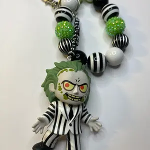 Beetle Juice Keychain Accessory with Green Beads and Striped Design for Fans