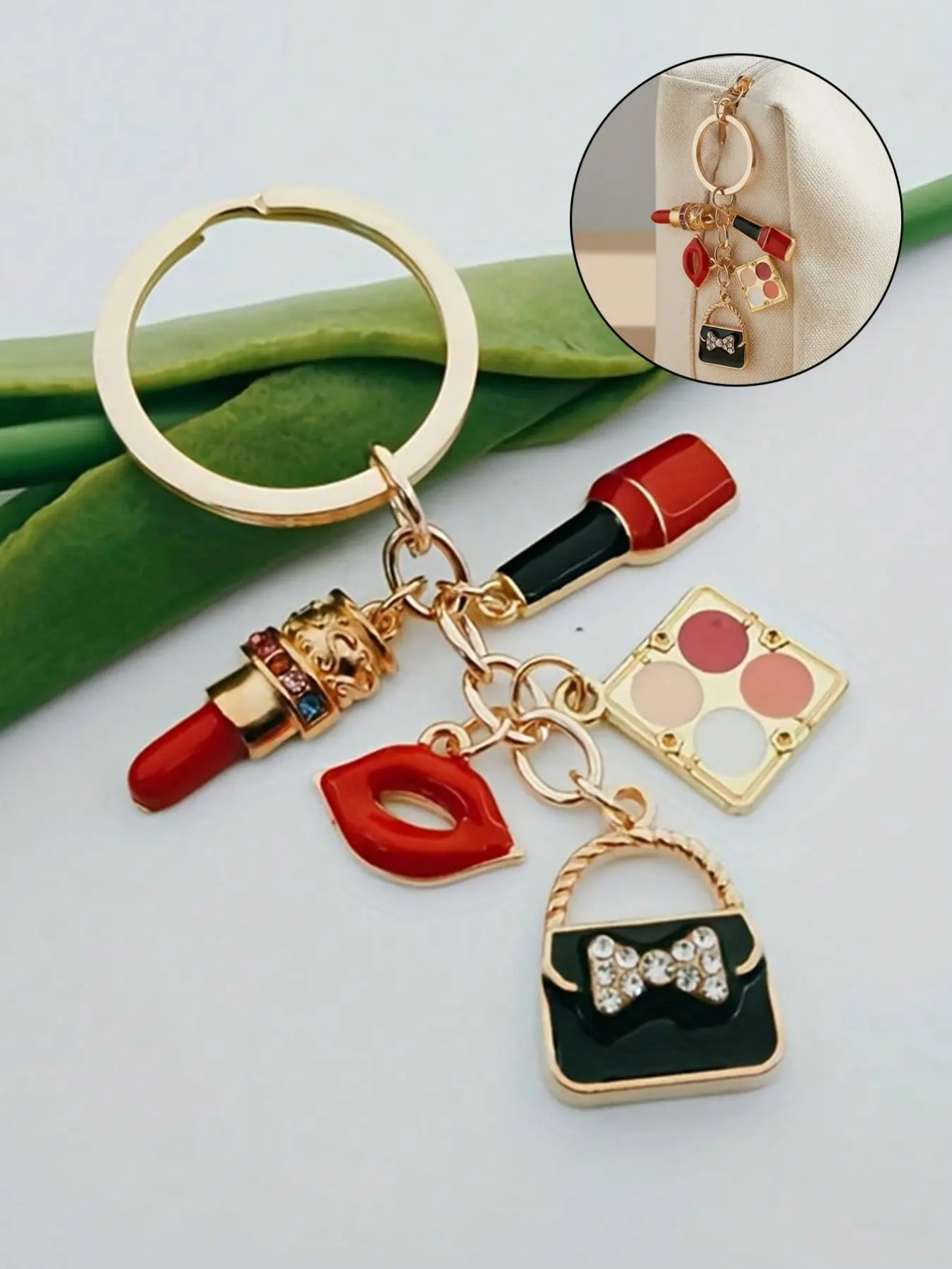 A fashionable red keychain, a charming enamel keychain, a cute metal round heart-themed keyring, an elegant alloy keychain, with eyeshadow palette, lipstick, handbag, and makeup accessories