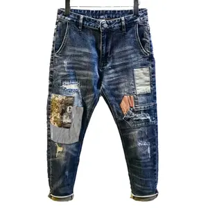 Artisan-Washed Tapered-Leg Denim Jeans with Vintage Patchwork & Distressing