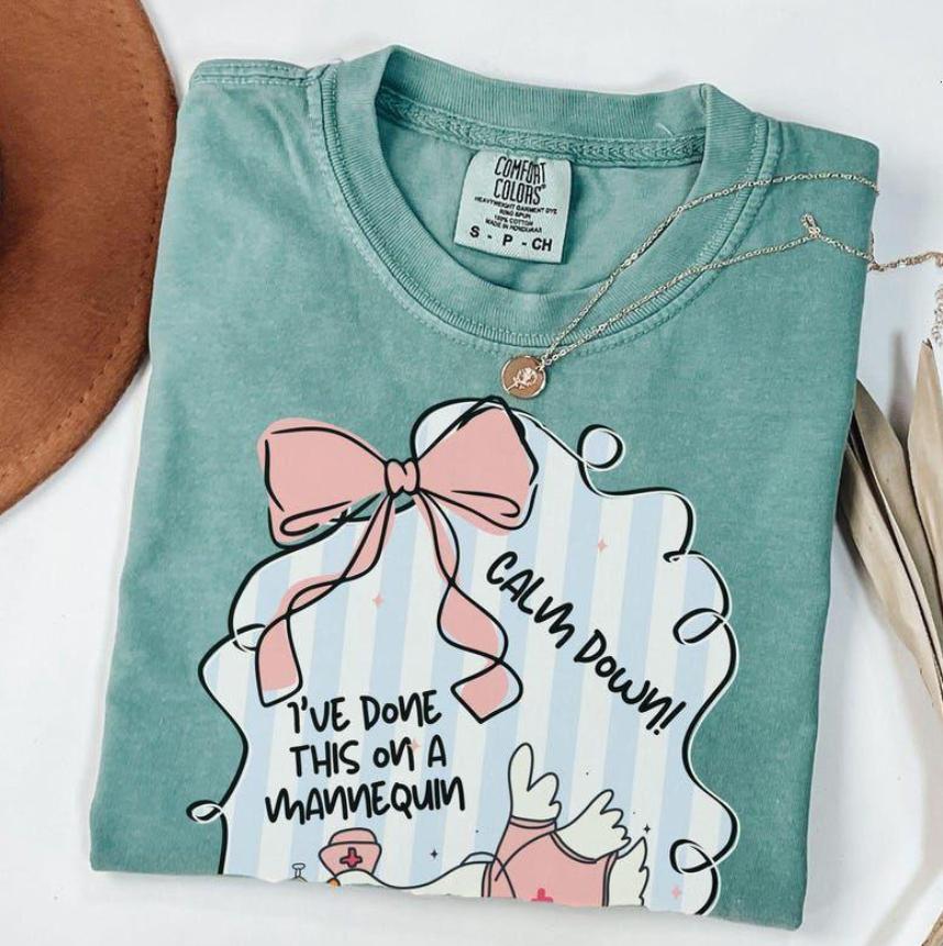 Comfort Colors Funny Nurse T-Shirt – Calm Down I’ve Done This On A Mannequin Once Tee, Cute Goose Graphic T-Shirt, Girly Medical Student Humor Top For Women