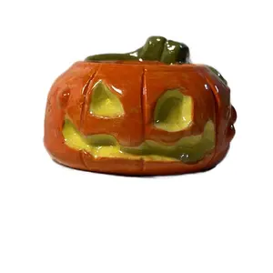 Jack o’ lantern Pumpkin shot glass / candle holder.  Handmade ceramic cup