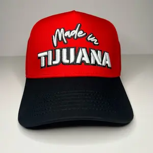 Made in Tijuana Baseball Hat - Red with Black Stripes, Curved Brim, and "Made in Tijuana" Text Design