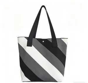 Striped knit tote bag — black, white, gray; woven handbag with diagonal color blocking