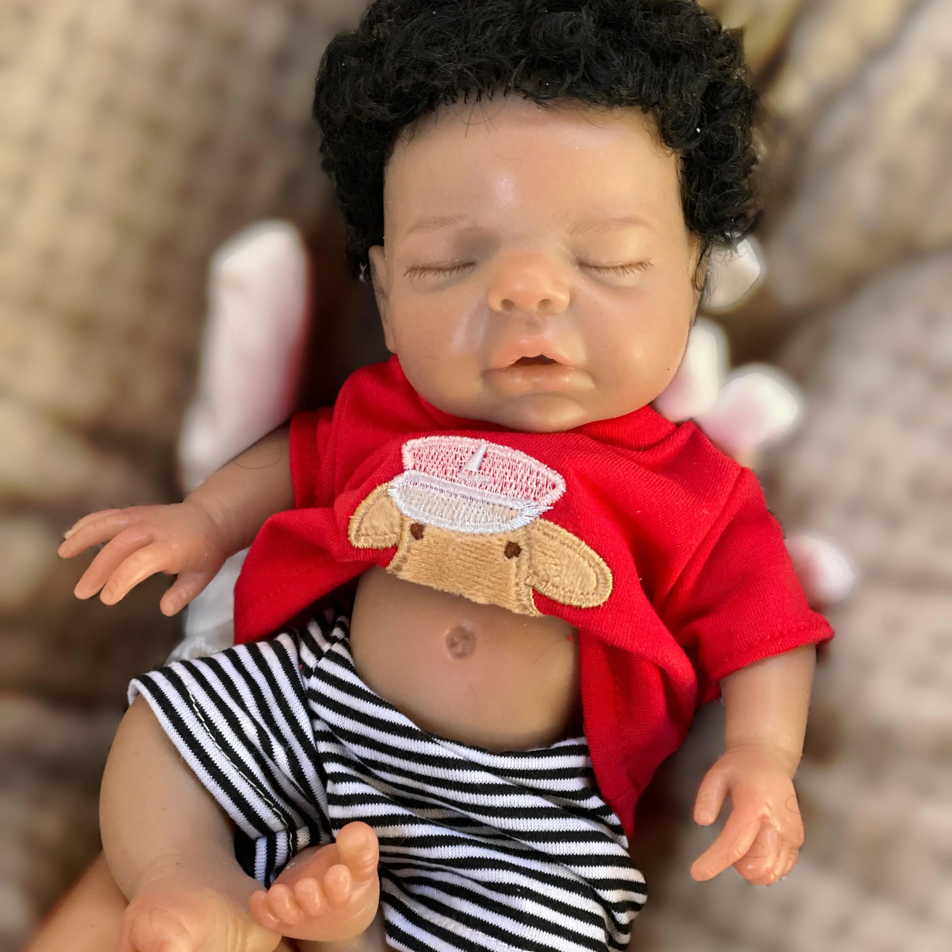 10-inch brown reborn baby girl doll, silicone material, black curly hair, handmade, realistic lifelike details, includes a bottle and birth certificate. Ideal as a birthday gift, for collectors, and a perfect gift for children.
