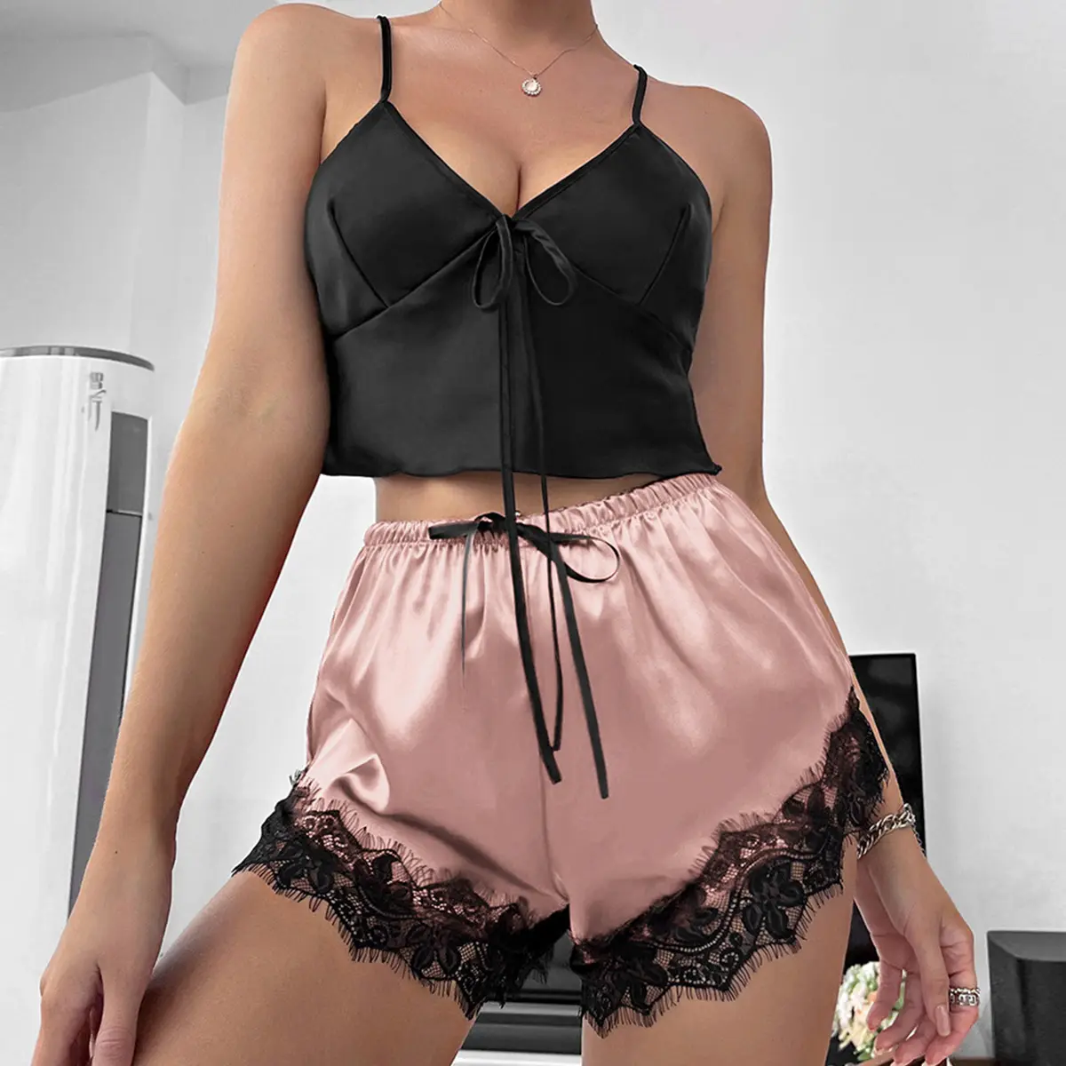Women's black and red color-block thin sleeveless pajama set, featuring a deep V-neck with tie closure and lace shorts. Available in multiple colors.