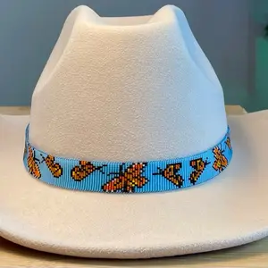 Loomed Seed Bead Orange Monarch Butterflies in Flight Hatband with a Matte Light Blue Background