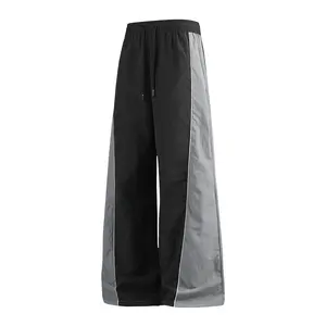 Men’s color-block wide-leg pants with a drawstring elastic waistband, casual athletic jogger pants with side piping