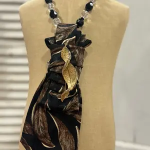 Vintage Tie Necklace with Black and Brown Patterned Design, Adjustable Strap, and Decorative Elements