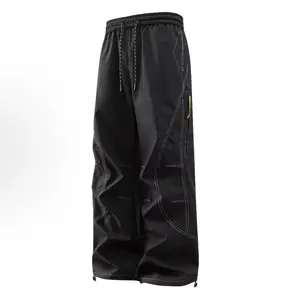 Men’s structured tactical cargo pants with a panelled design and faux-zipper detailing; outdoor functional shell pants with a straight, loose, drapey cut for spring and autumn; men’s apparel.
