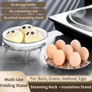 Food-grade stainless steel foldable steamer rack for steaming eggs, round multi-functional household steamer with perforated design.