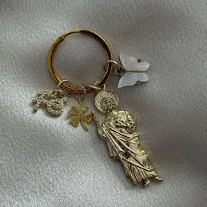 San Judas Keychain with Butterfly Charm and Clover Accents Gold-Tone Design